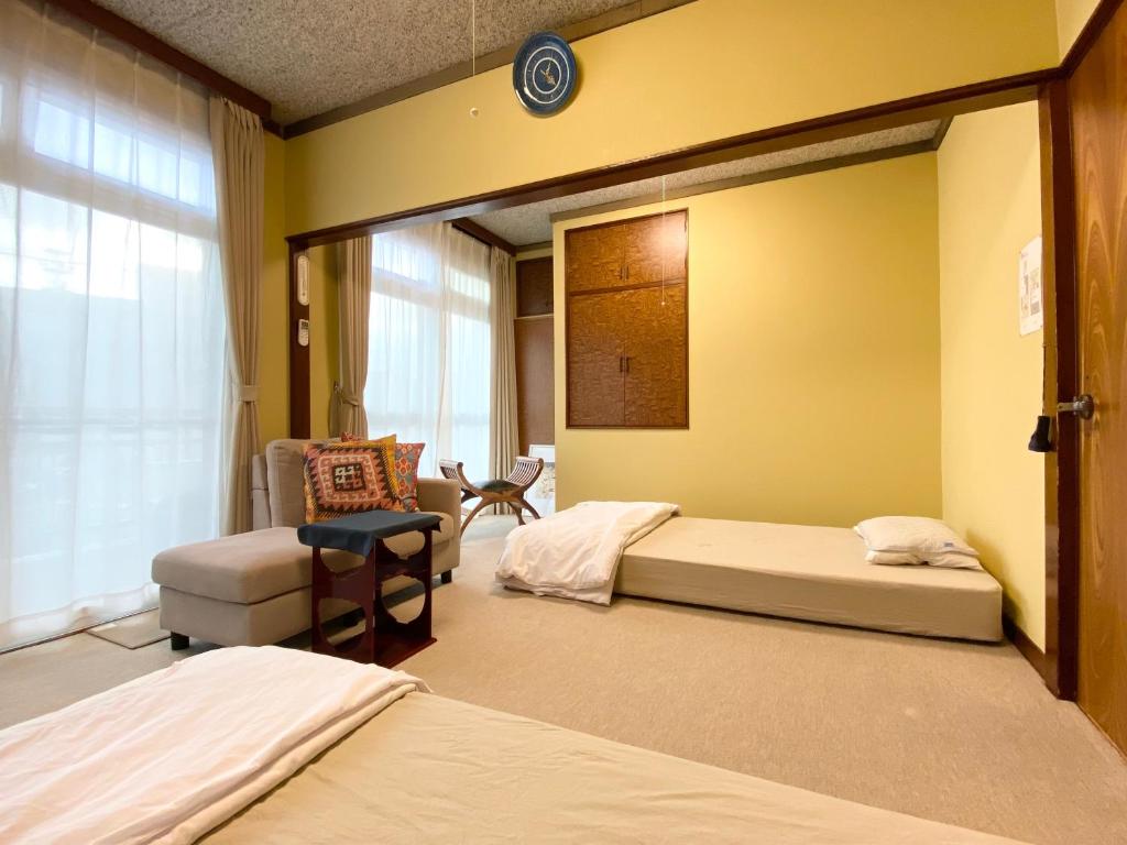 Postel nebo postele na pokoji v ubytování toya町家-chitose