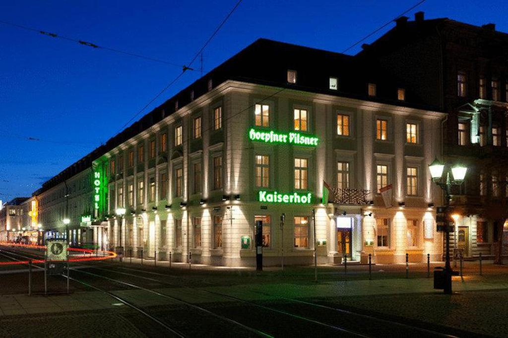 ein Gebäude mit Neonschildern an der Seite in der Unterkunft Kaiserhof in Karlsruhe