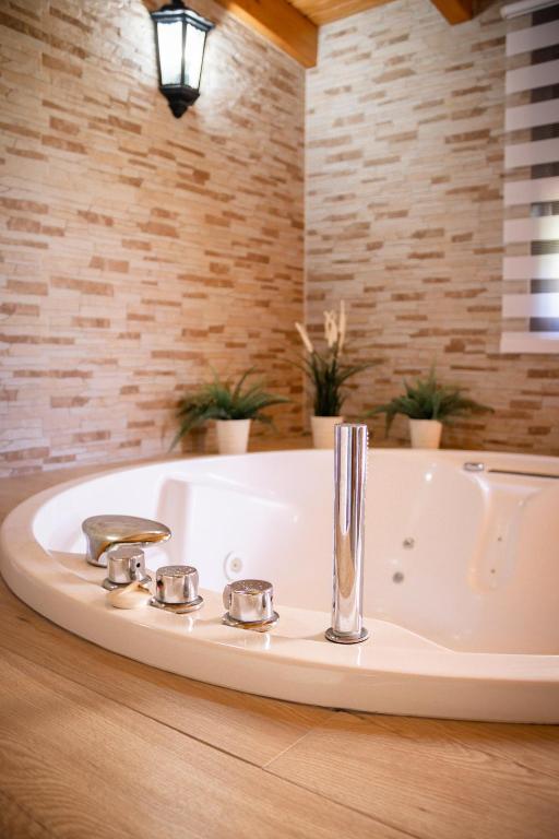 a white sink in a bathroom with plants at Casas El Suspiro in Zahora