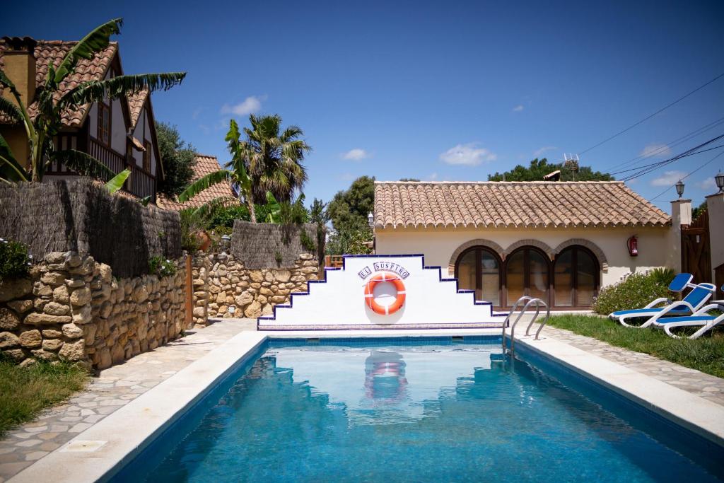 a swimming pool in front of a house at Casas El Suspiro in Zahora