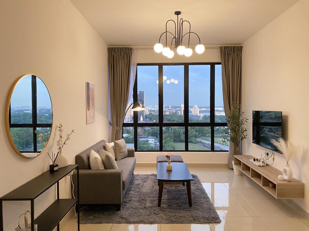 a living room with a couch and a table at Veranda-2BR,4pax I 5mins to CIQ and KSL I Fast-Wifi in Johor Bahru