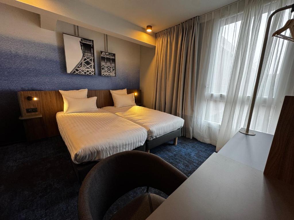 Hôtel AKENA Serris - Val d'Europeにあるベッド