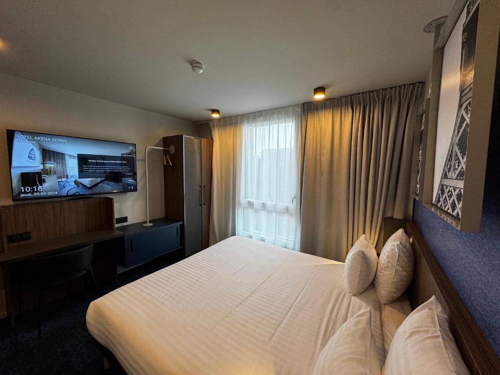 Hôtel AKENA Serris - Val d'Europeにあるテレビまたはエンターテインメントセンター