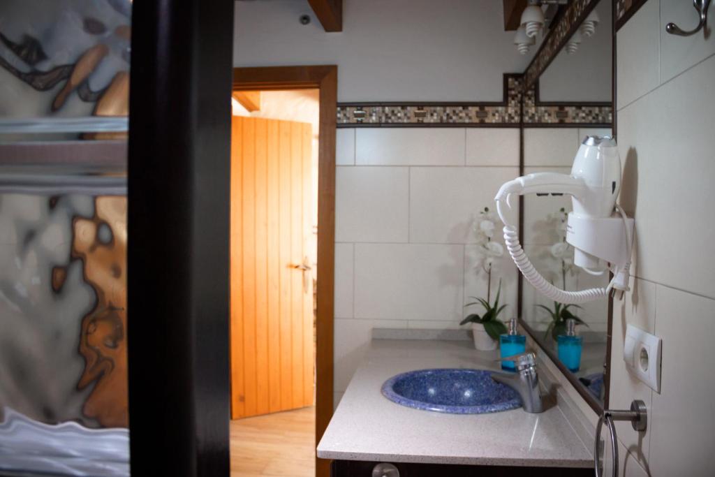 a bathroom with a sink and a mirror at Casas El Suspiro in Zahora