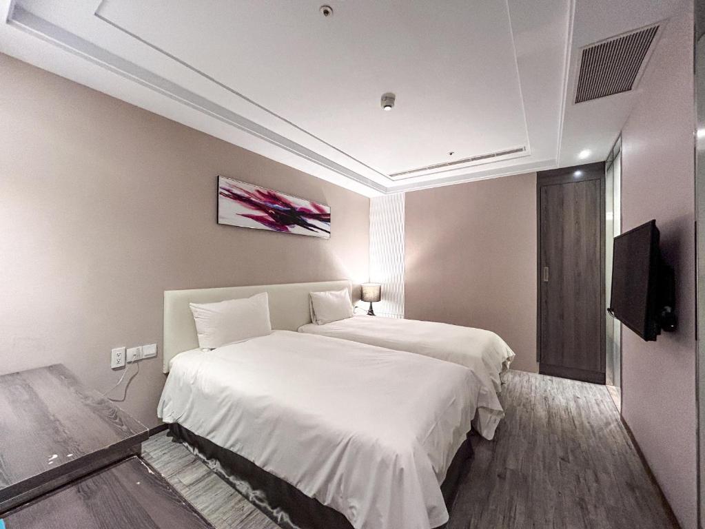 Postel nebo postele na pokoji v ubytování Royal Fine Hotel