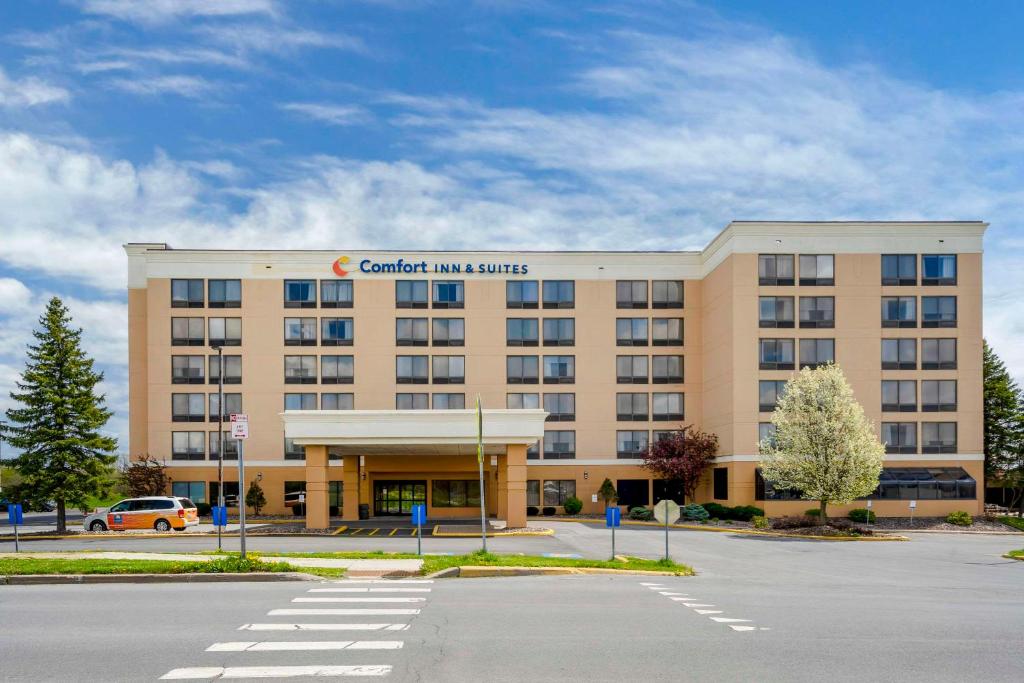 a hospital building with a car parked in a parking lot at Comfort Inn & Suites Watertown - 1000 Islands in Watertown