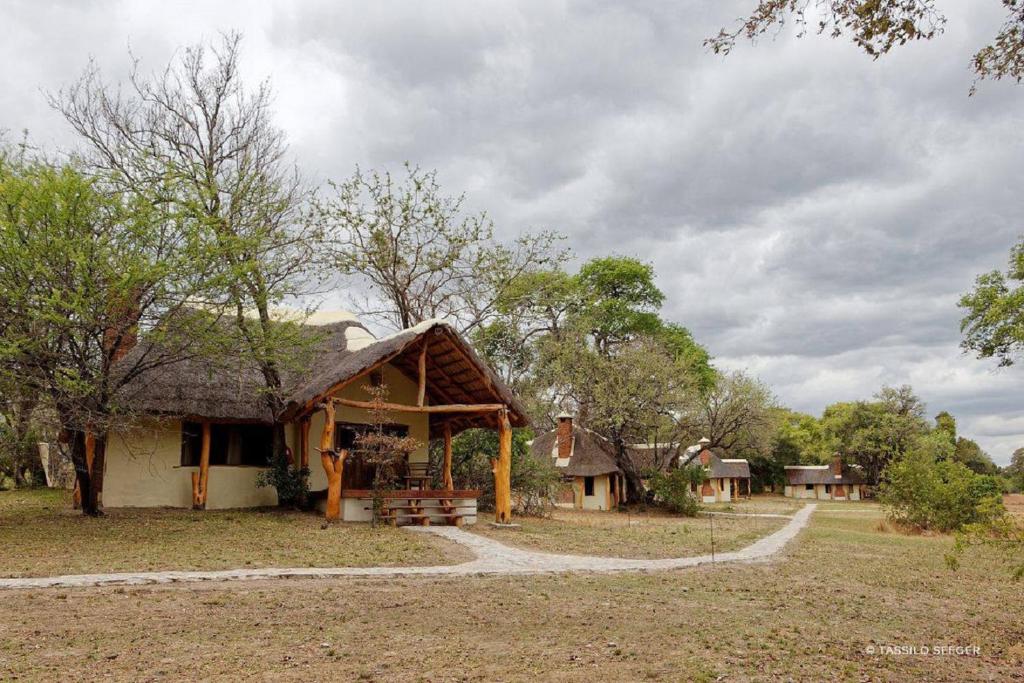 a small hut with a bench in a field at Kafue River Lodge in Mulola