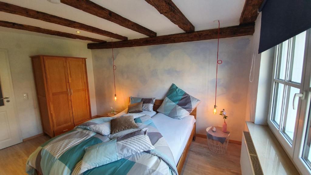 a bedroom with a bed with pillows on it at Kellerei5 Ferienwohnung 2 in Ochsenfurt