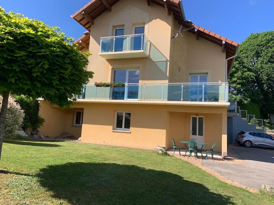 a large house with two chairs in front of it at Maison avec jardin Gérardmer L'AUTOUR in Gérardmer