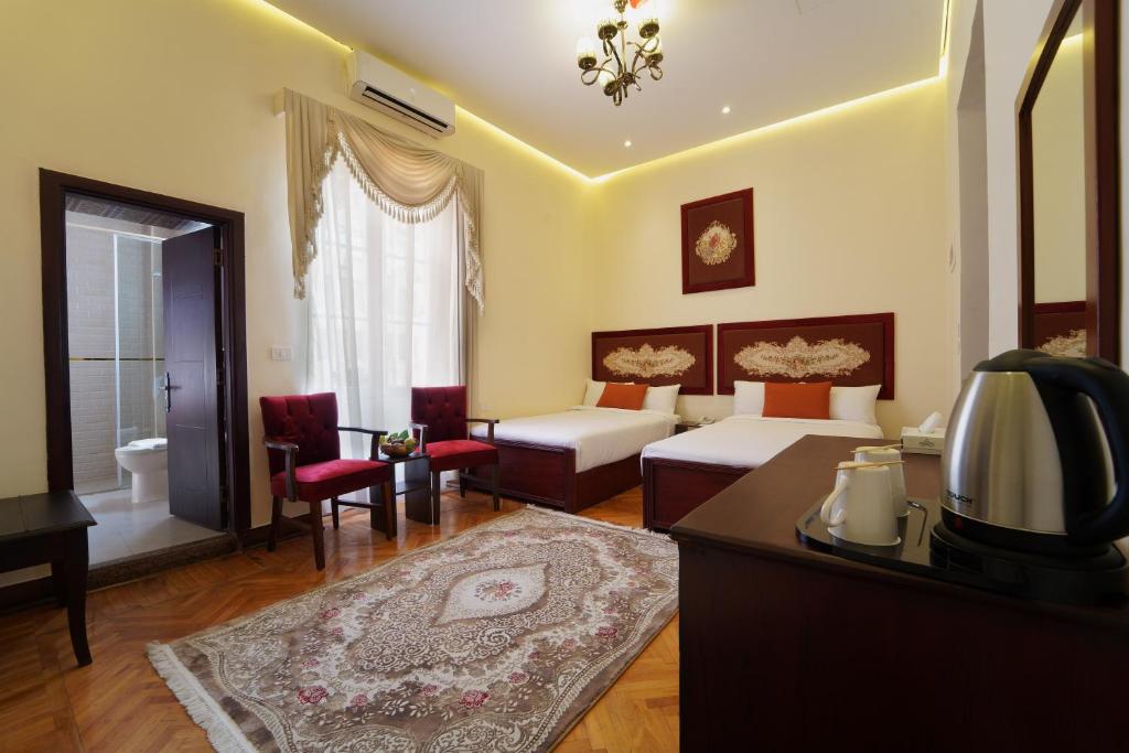 Postel nebo postele na pokoji v ubytování Victoria Cairo Hotel