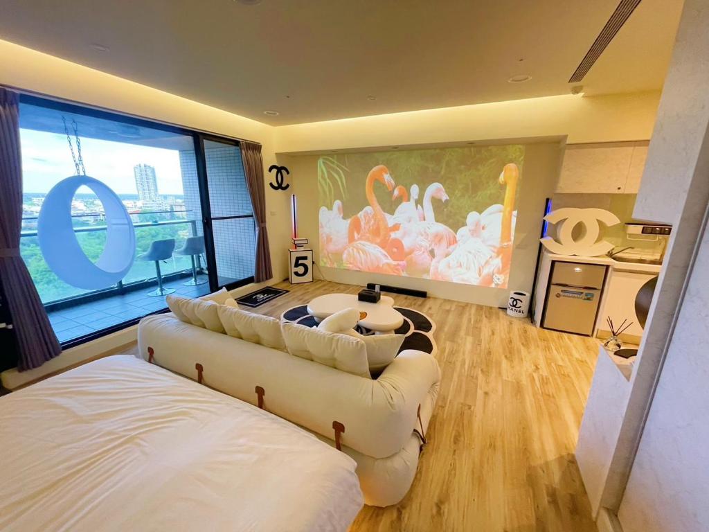 a room with two beds and a large painting on the wall at 光嶼海溫泉海景無邊際泳池豪華套房 in Hsin-hsing