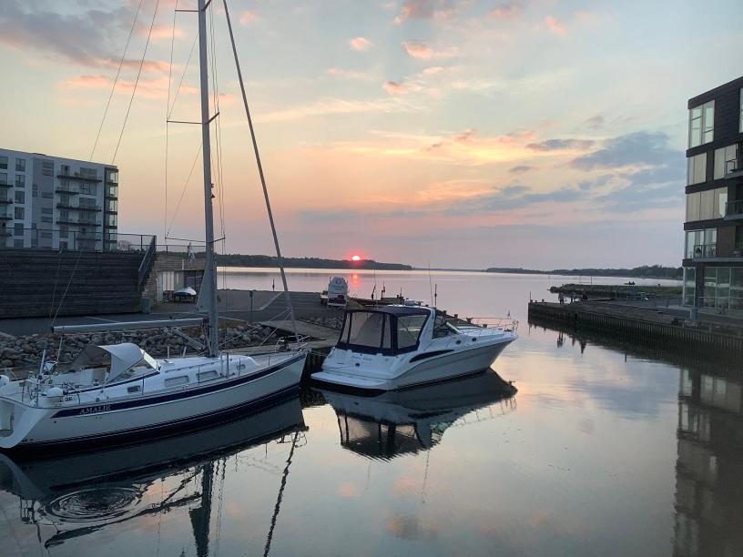 two boats are docked at a dock in the water at MarinaVilla in Nykøbing Falster