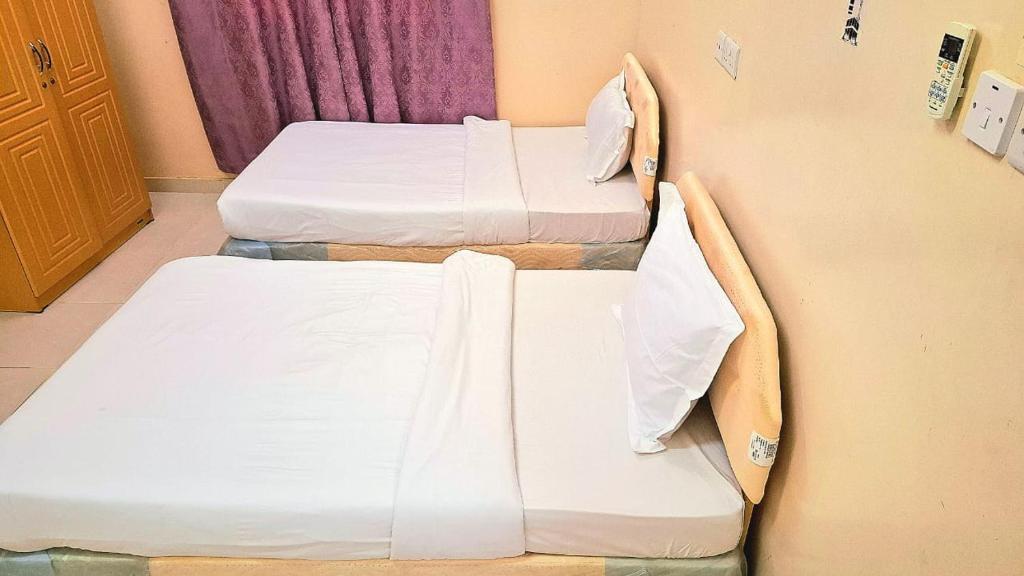 Postel nebo postele na pokoji v ubytování Al Afiah Corniche Hotel Apartment