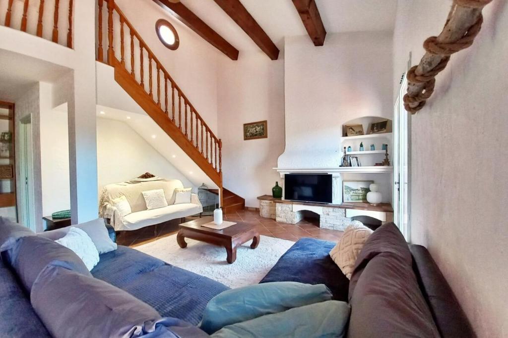 Una sala de estar con un sofá azul y una mesa. en Family house - quiet - common pool - Fréjus, en Fréjus