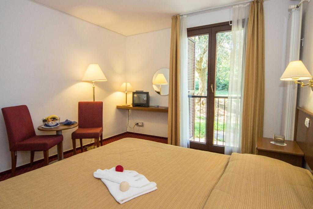 Postel nebo postele na pokoji v ubytování Hotel Vile Park