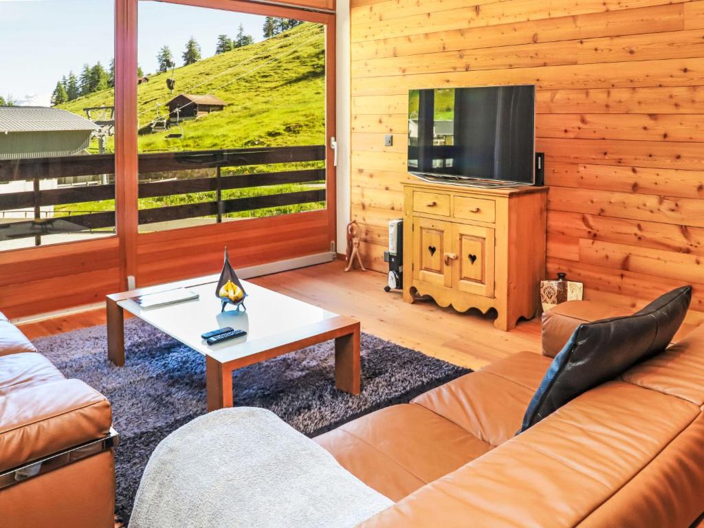 a living room with a couch and a tv at Apartment Rosablanche D 203A by Interhome in Siviez