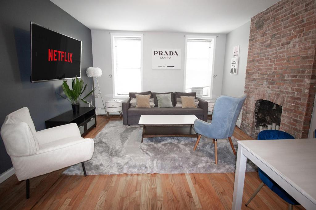a living room with a couch and two chairs at Fashionable 1-Bedrm Apt 15 Min to Manhattan in Hoboken
