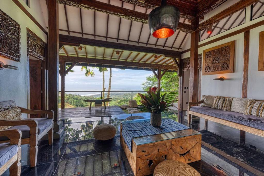 a living room with a couch and a table at Bali Villa Jungle Paradise - Uvita in Uvita