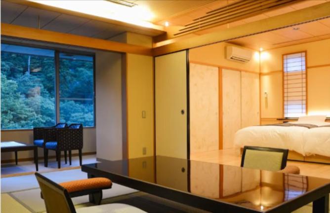Postel nebo postele na pokoji v ubytování Arima Onsen Gekkoen Korokan