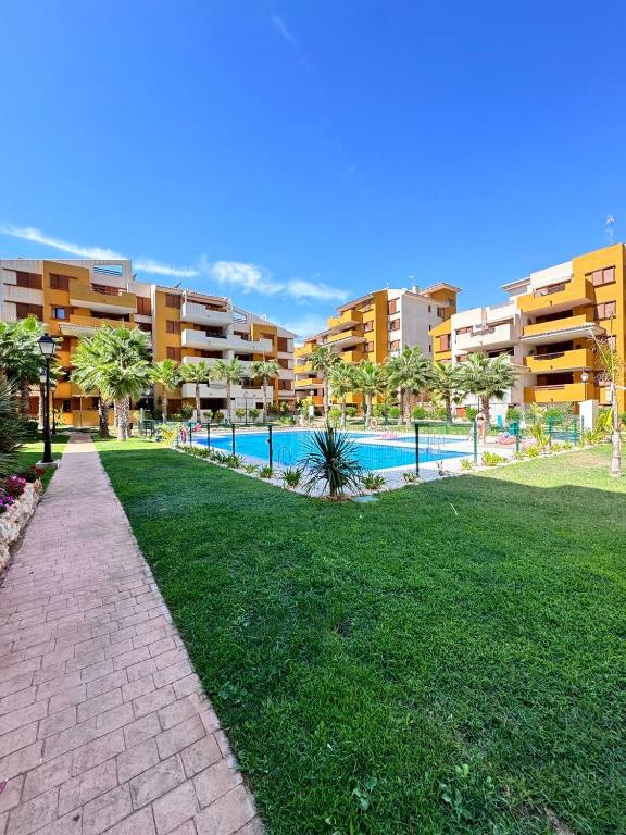 a resort with a swimming pool and some buildings at La Recoleta Residence Punta Prima in Torrevieja