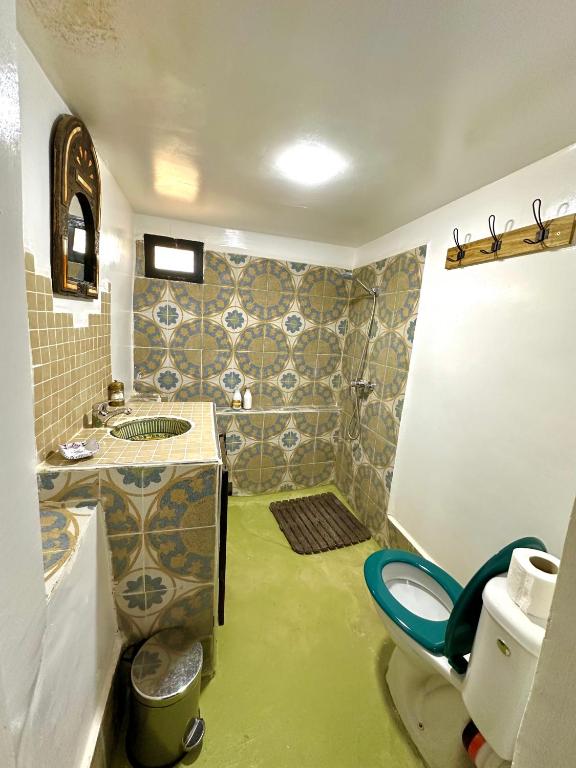 a bathroom with a sink and a toilet in it at Kasbah El Hajja in Aït Benhaddou