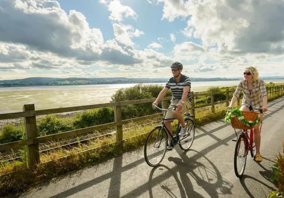 Ein Mann und eine Frau, die Fahrrad fahren. in der Unterkunft Gatelodge - Charming 2-Bed Cottage, Exmouth - Sleeps 3 in Exmouth