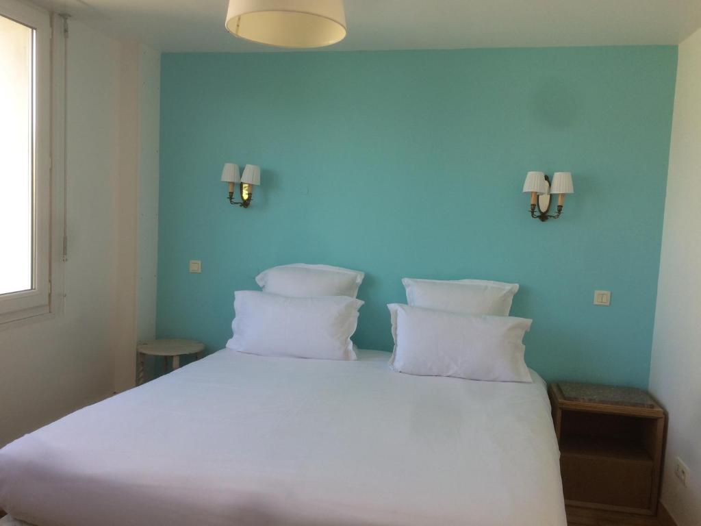 Postel nebo postele na pokoji v ubytování Hotel Richelieu