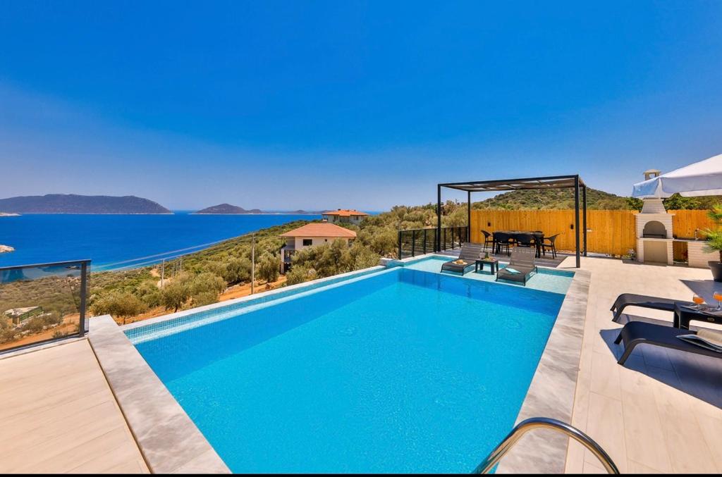 a swimming pool with a view of the water at Villa simurg in Kas