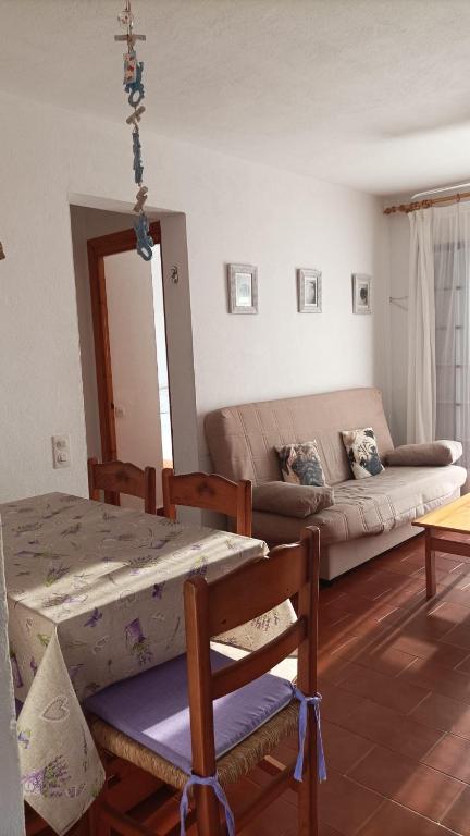 a living room with a couch and a table at Apartamento Menorca son parc in Son Parc