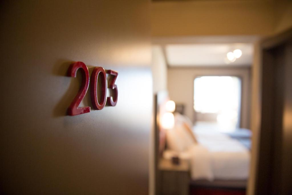 Postel nebo postele na pokoji v ubytování Hotel Bristol Verbier