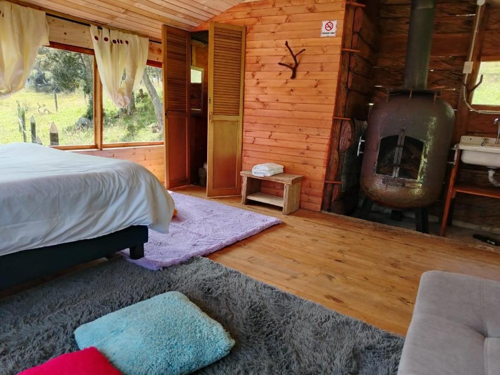 Postel nebo postele na pokoji v ubytování CABAÑAS ALASKA