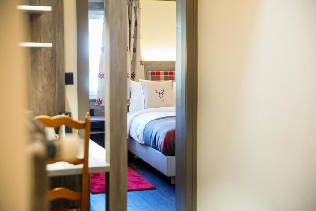 Postel nebo postele na pokoji v ubytování Hotel Bristol Verbier
