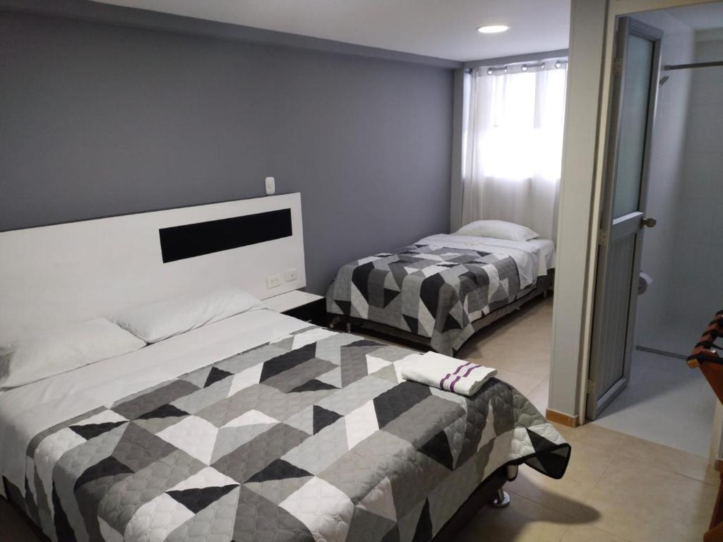 a bedroom with two beds in a room at Hotel y Cabañas Rio Mayo in Chachagüí