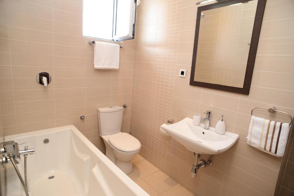 a bathroom with a toilet and a sink and a tub at Apartments Belvedere in Belgrade
