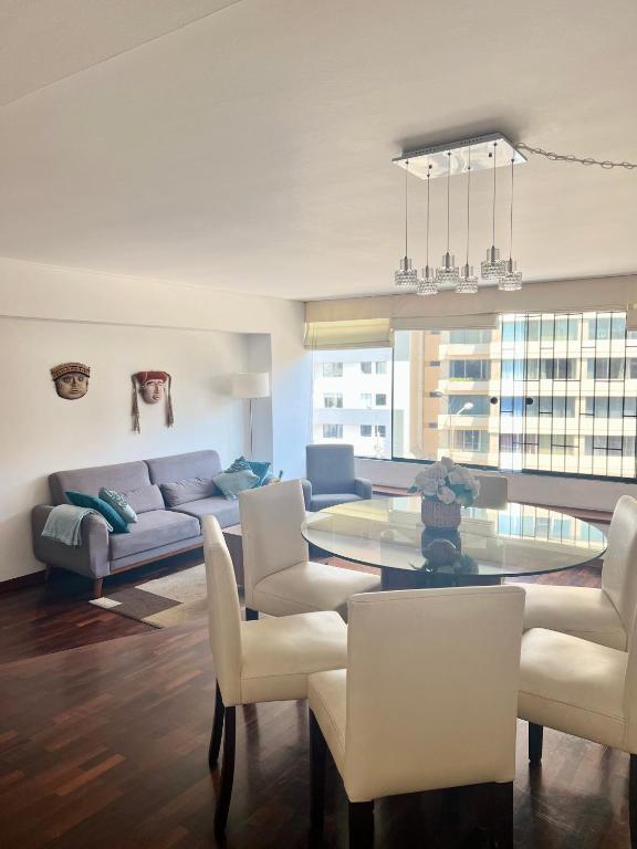 a living room with a couch and a table and chairs at Maywa at Central Miraflores in Lima