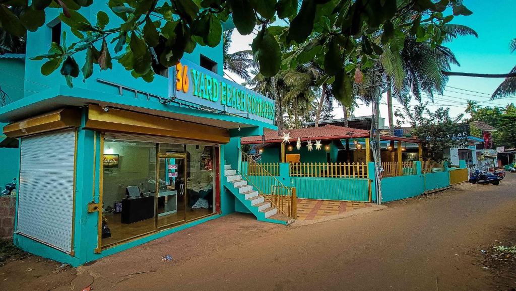 a blue building on the side of a street at 36 Yard Beach Cottages in Old Goa