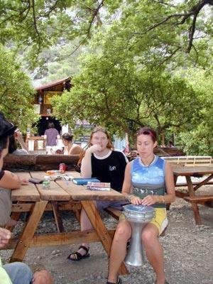 a group of people sitting at a picnic table at Bayrams Tree Houses in Olympos