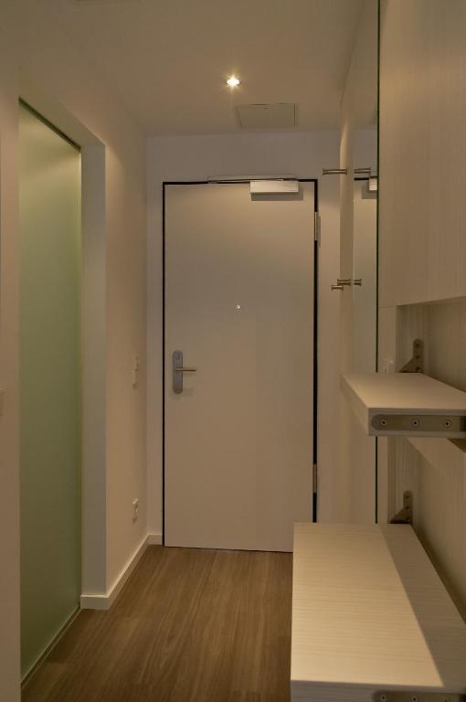 a room with a door and a sink and a counter at Super 8 by Wyndham Munich City North in Munich