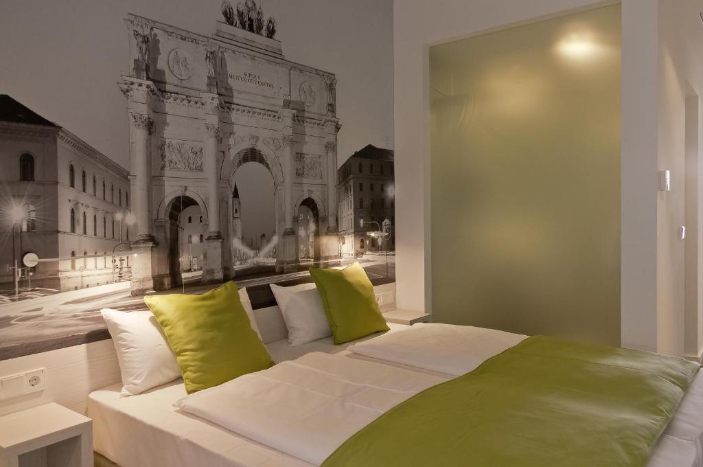 a bedroom with a large bed with yellow pillows at Super 8 by Wyndham Munich City North in Munich