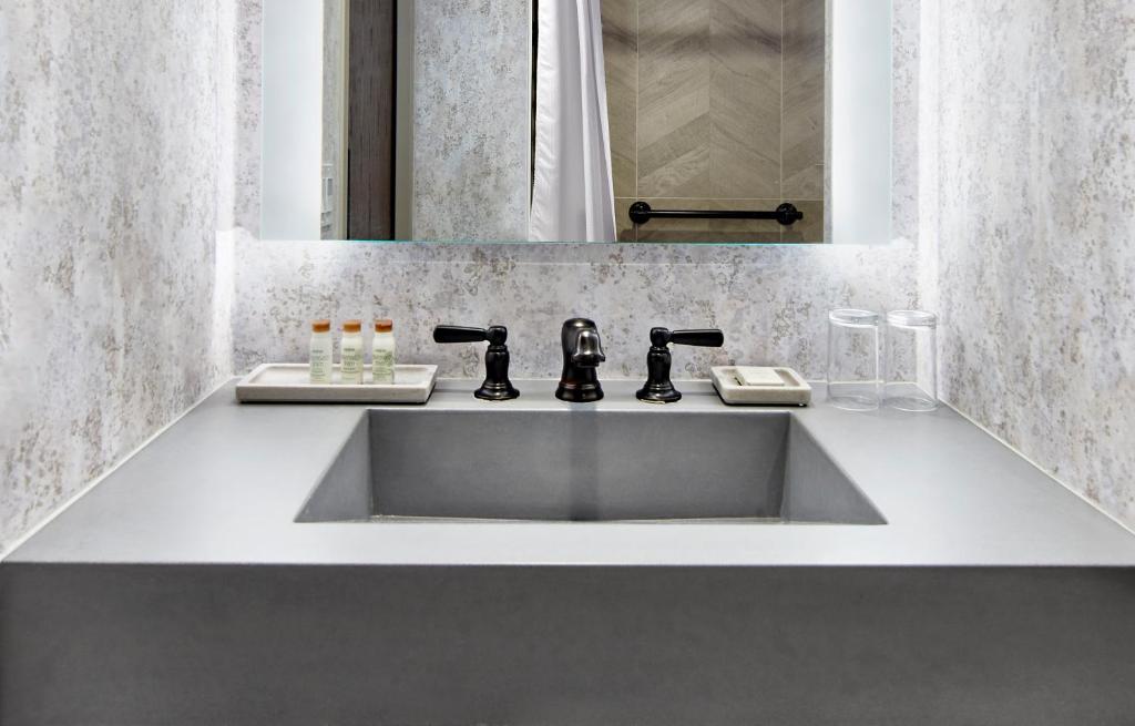 a bathroom with a sink and a mirror at Renaissance Mobile Riverview Plaza Hotel in Mobile