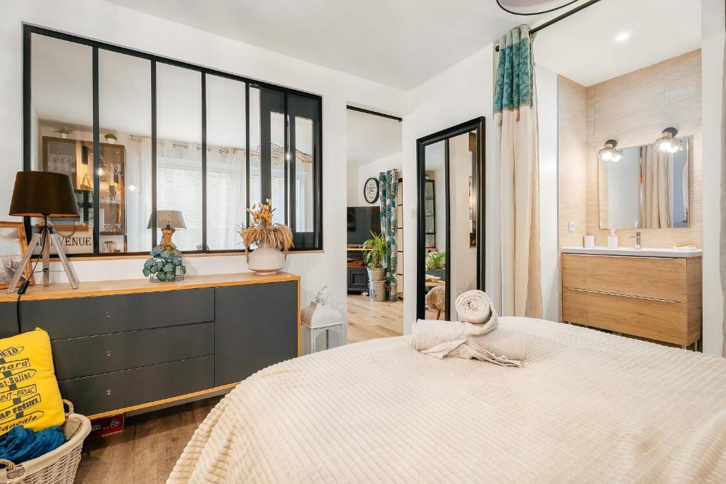 a bedroom with a large bed and a large window at Chambre aspect loft in Baguer-Pican