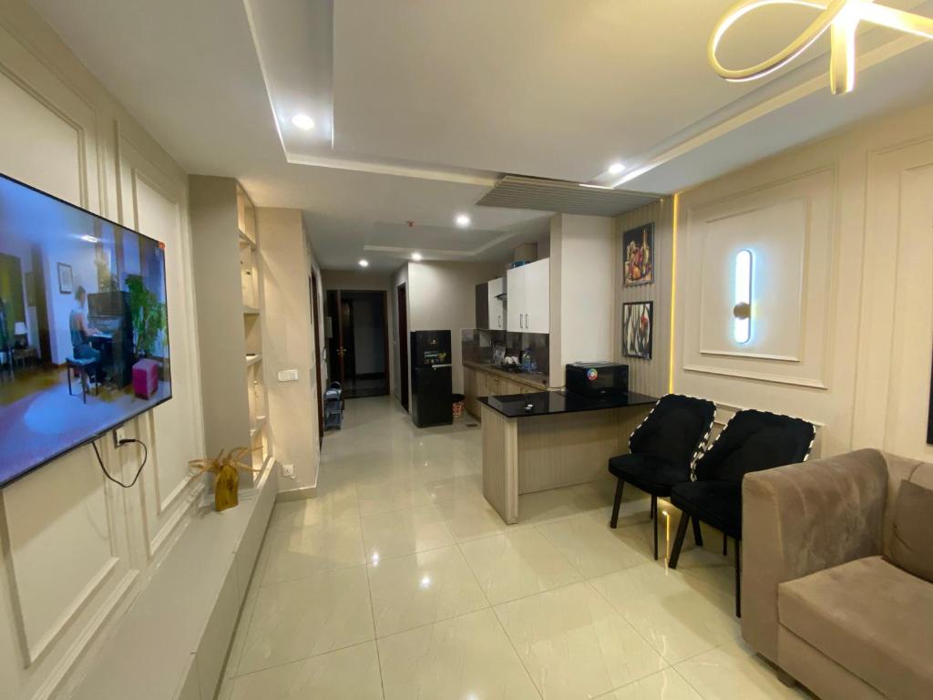 a large living room with a couch and a tv at HOME DEALS appartment in Darwāla
