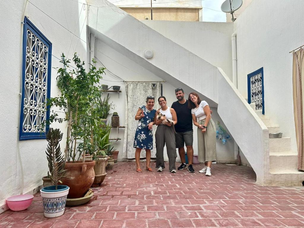 a group of people standing next to a staircase at Maison d'hôte Chama in Kairouan