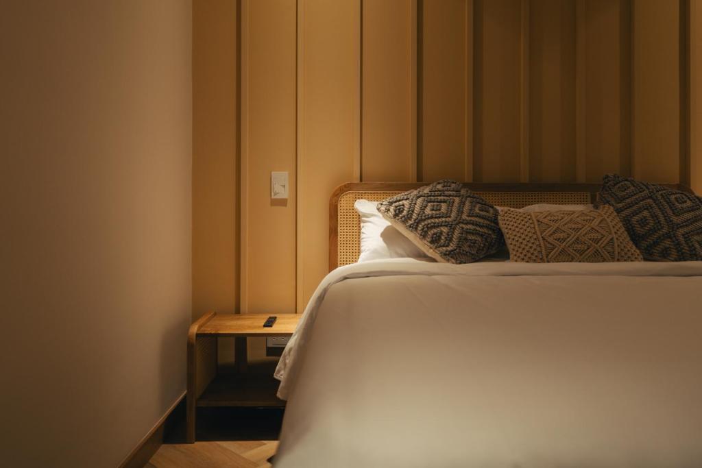 Postel nebo postele na pokoji v ubytování Hotel Boutique Roomzz Laureles