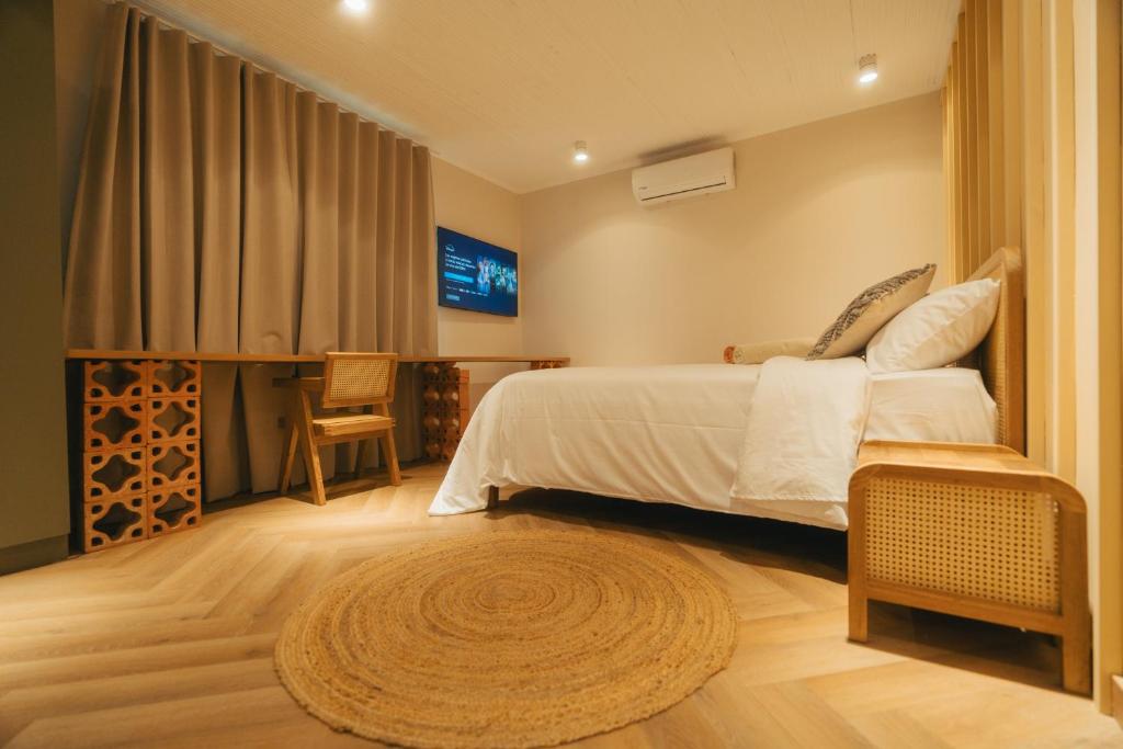 Postel nebo postele na pokoji v ubytování Hotel Boutique Roomzz Laureles