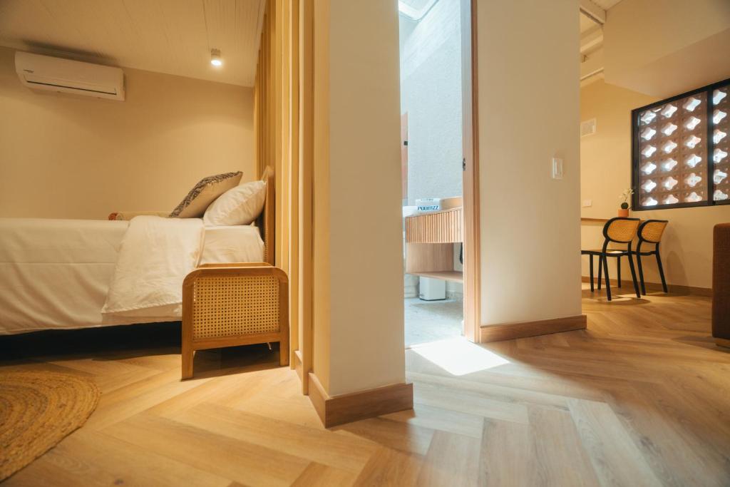 Postel nebo postele na pokoji v ubytování Hotel Boutique Roomzz Laureles