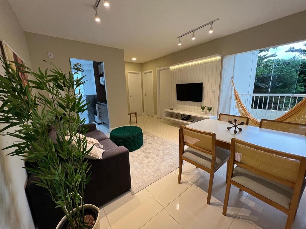 a living room with a couch and a table at Confortável 2 quartos a 4 min da orla in Santa Maria