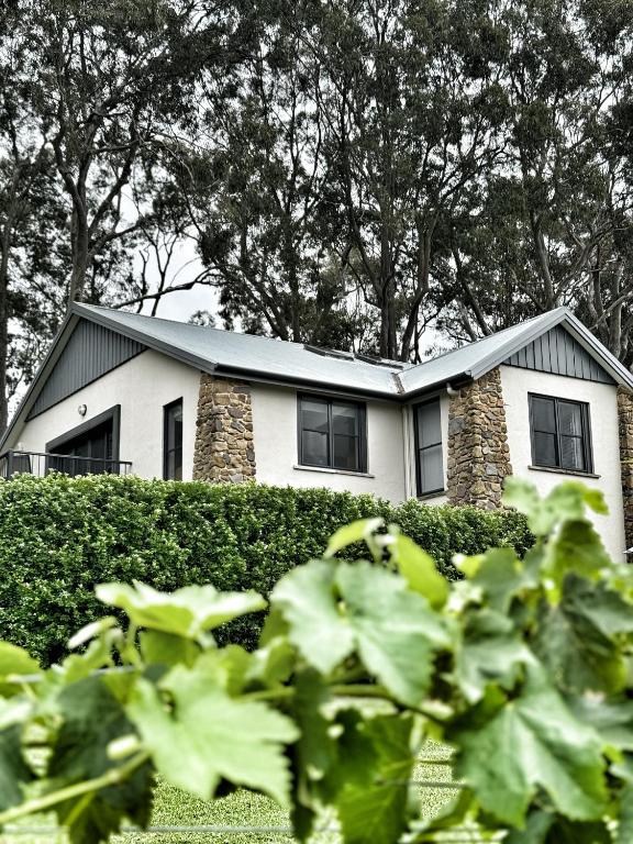 a white house with a gray roof at Bonvilla Estate in Pokolbin