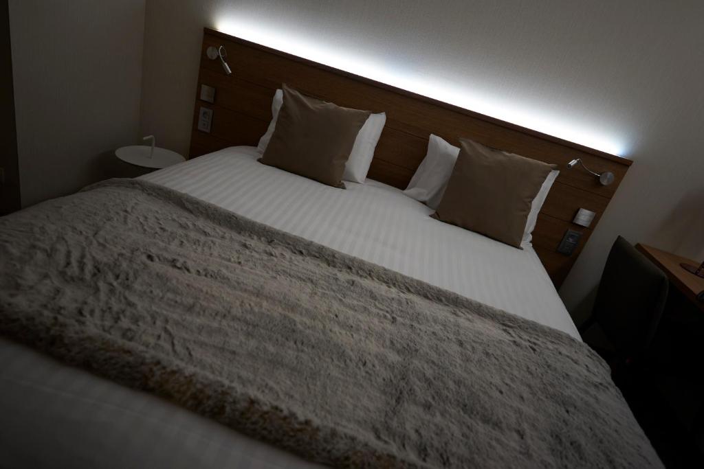 Postel nebo postele na pokoji v ubytování Hotel La Caleche