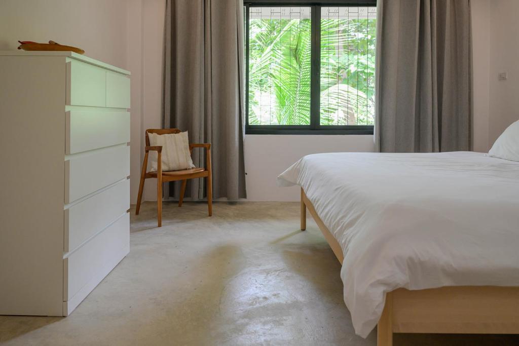 Postel nebo postele na pokoji v ubytování Boonya Swiss Home